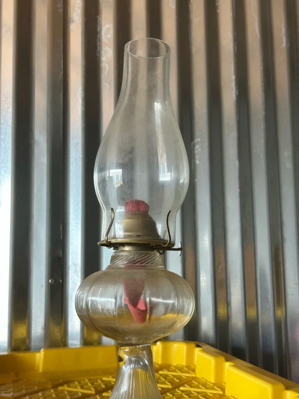 vintage clear glass kerosene oil lamp features a bulbous font and a ribbed base